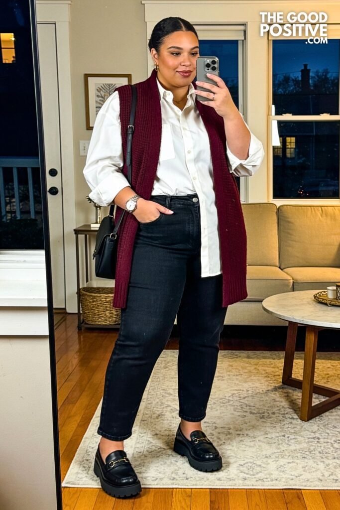 Burgundy Sweater Vest Over White Poplin Shirt With Black Straight Jeans And Loafers